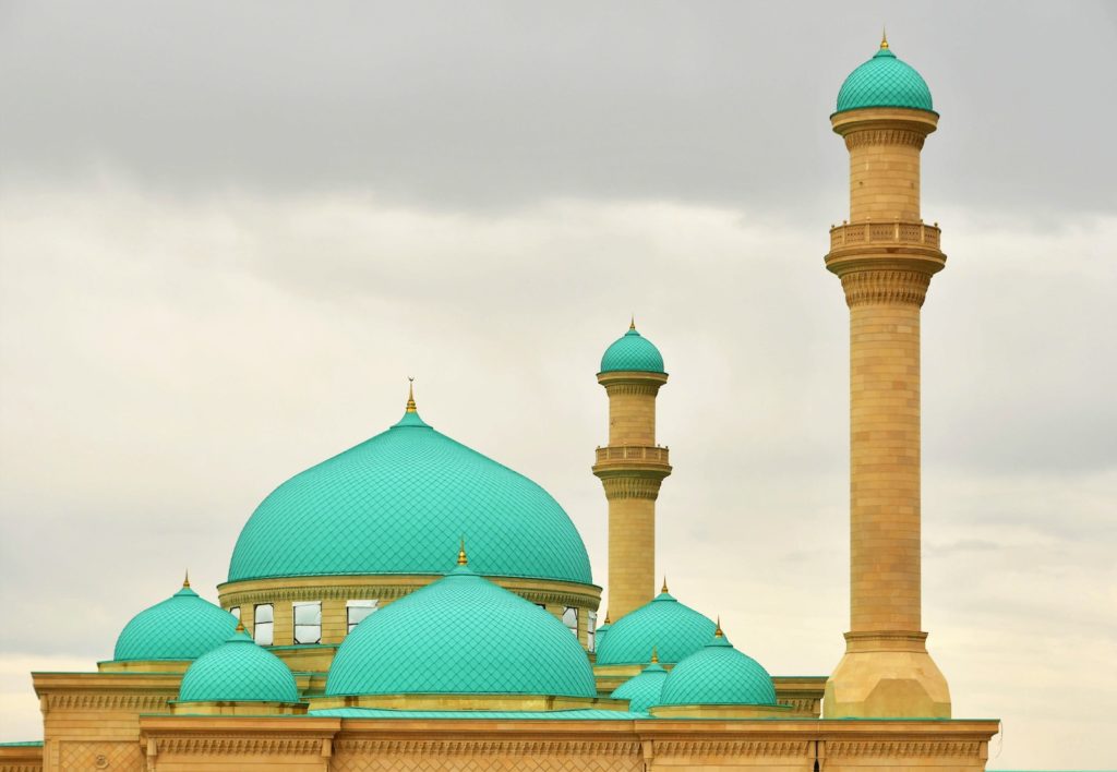 a large blue building with two tall towers